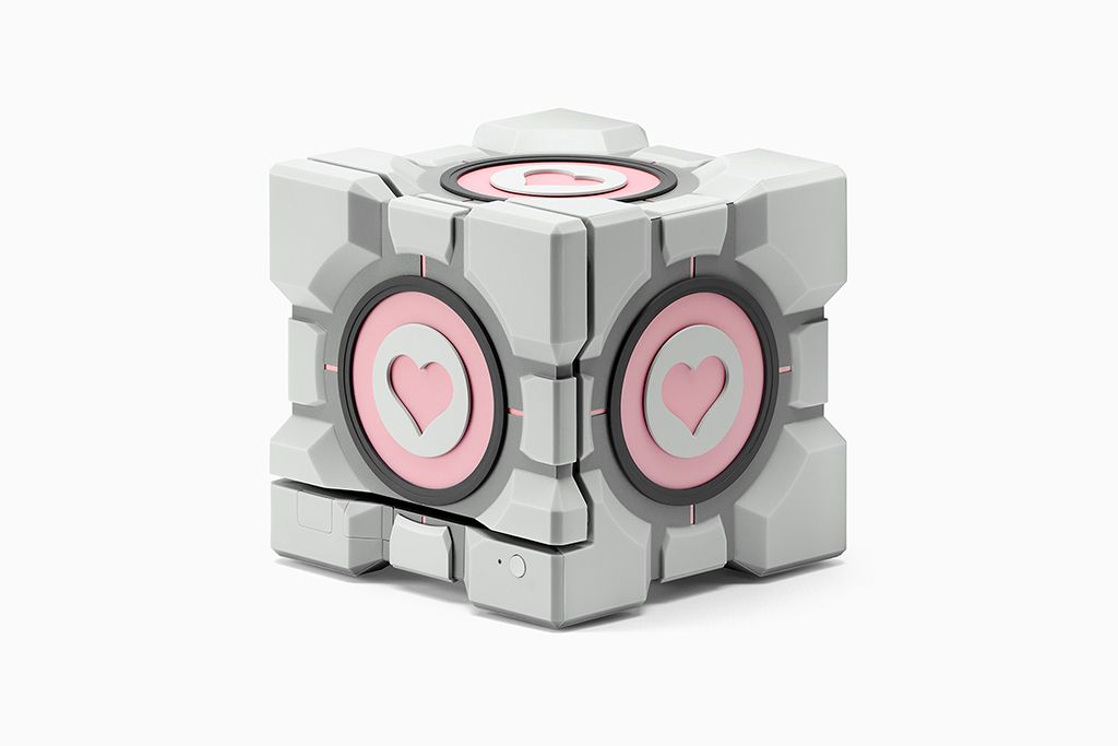 A Steam Machine on an angle with a dbrand Companion Cube enclosure affixed to the system.