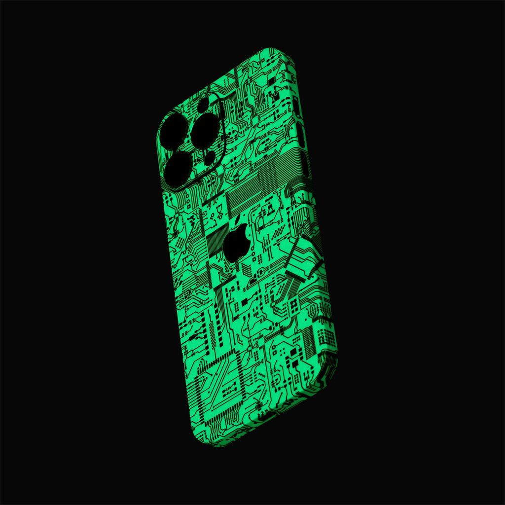 An iPhone 16 Pro Max at an angle, seen from the back. The device has our Circuit Board Skin on it, showing the fluorescent green tone of the material on a black background.