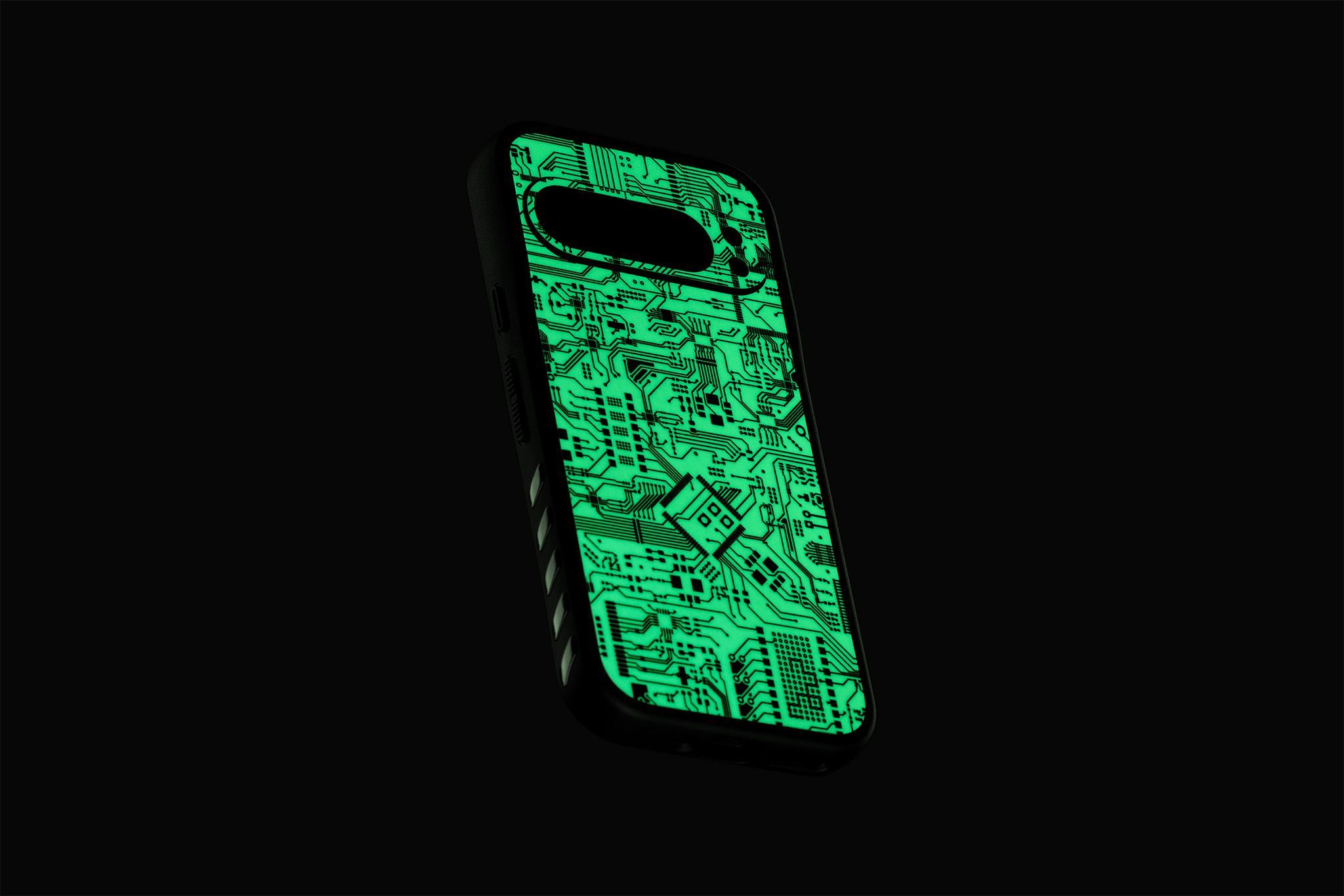 A Pixel 9 Pro with our Grip Case applied, seen from the back. The Grip Case has a Glow Circuit Grip Skin applied on the back plate, showing the fluorescent tone against a black backdrop.