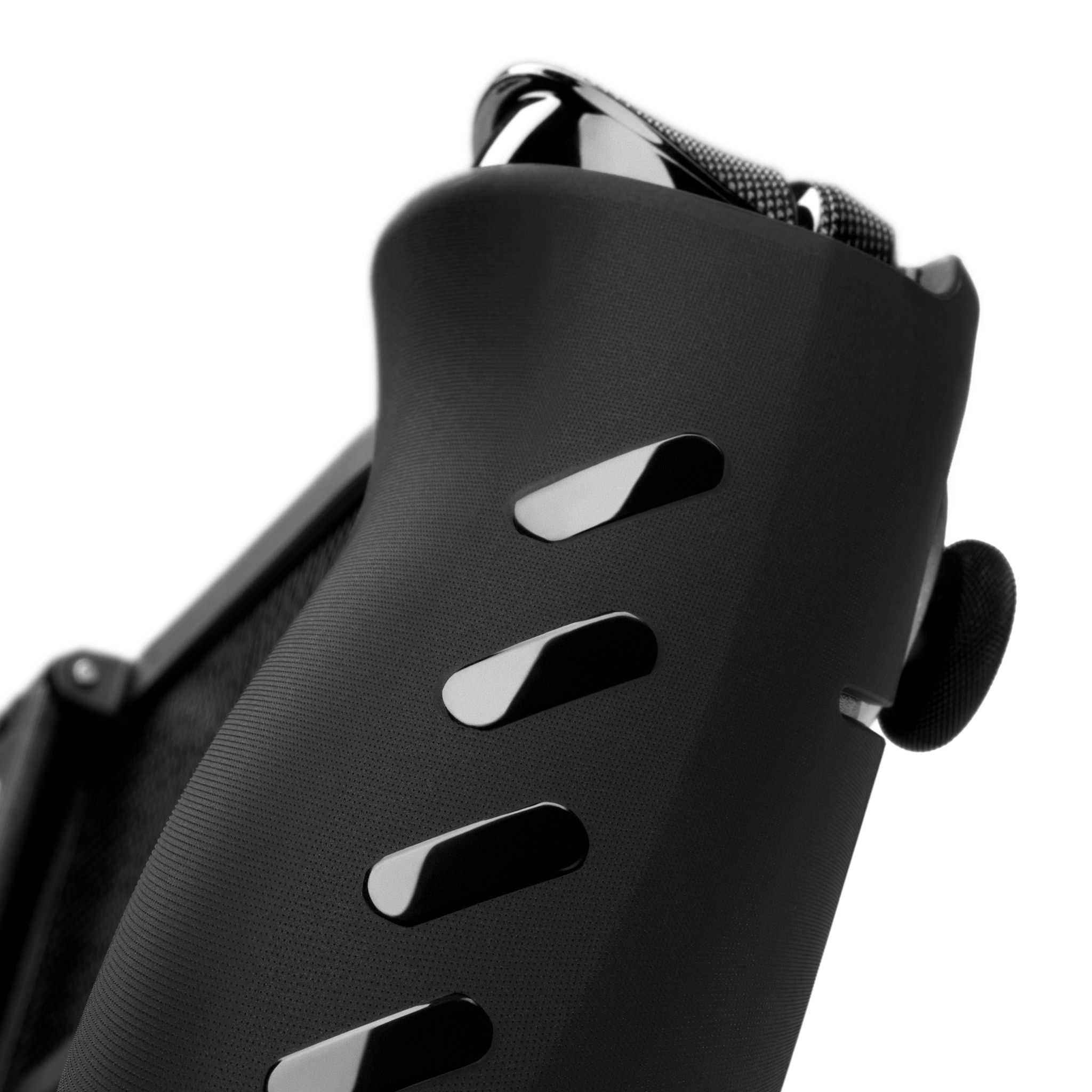 An ROG Xbox Ally X20 with our Killswitch applied to it, seen at a close-up angle from below by the side grips. Our liquid-black grip strips are visible on the side of the case.