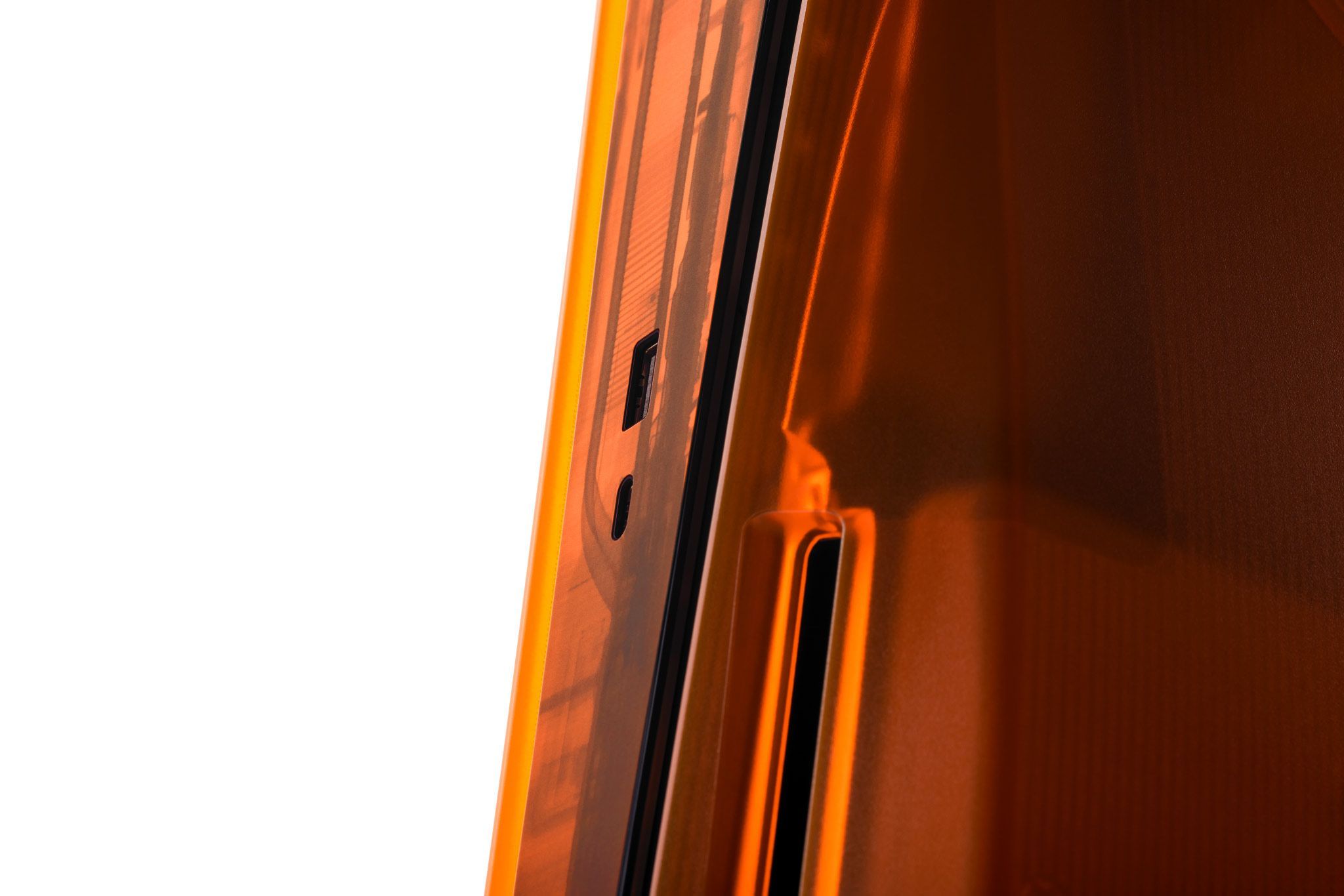 A close-up of a Disc Edition PlayStation 5 with our Fire Orange Middle Skin and Darkplates applied. The Disc Drive is prominently shown in orange. 