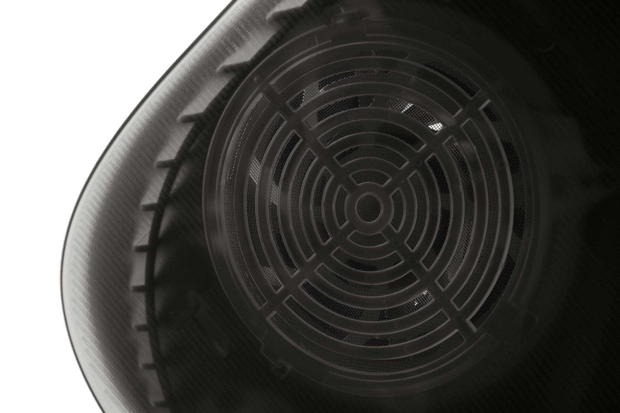 The side of a PlayStation 5, with our Smoke Black Darkplates applied. The image zooms in and prominently displays the air vents for added ventilation present on our Darkplates.
