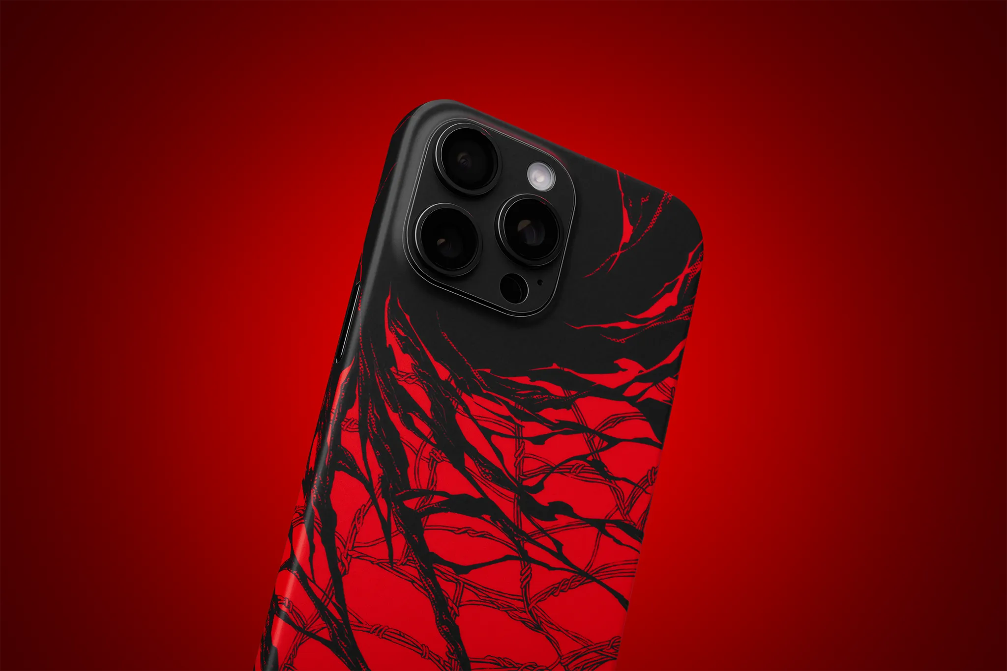 An iPhone 14 Pro Max seen from the back, with our Carnage Skin applied to it. The Skin covers the back of the device, along with the camera module. 