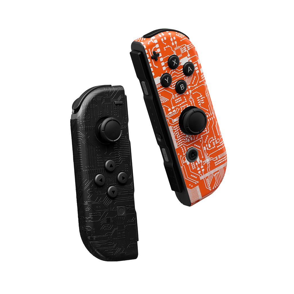 Two Switch 2 Joy-Cons floating against a white backdrop. The left Joy-Con is skinned in our Dark Circuit material, and the right Joy-Con is skinned in our Short Circuit material.