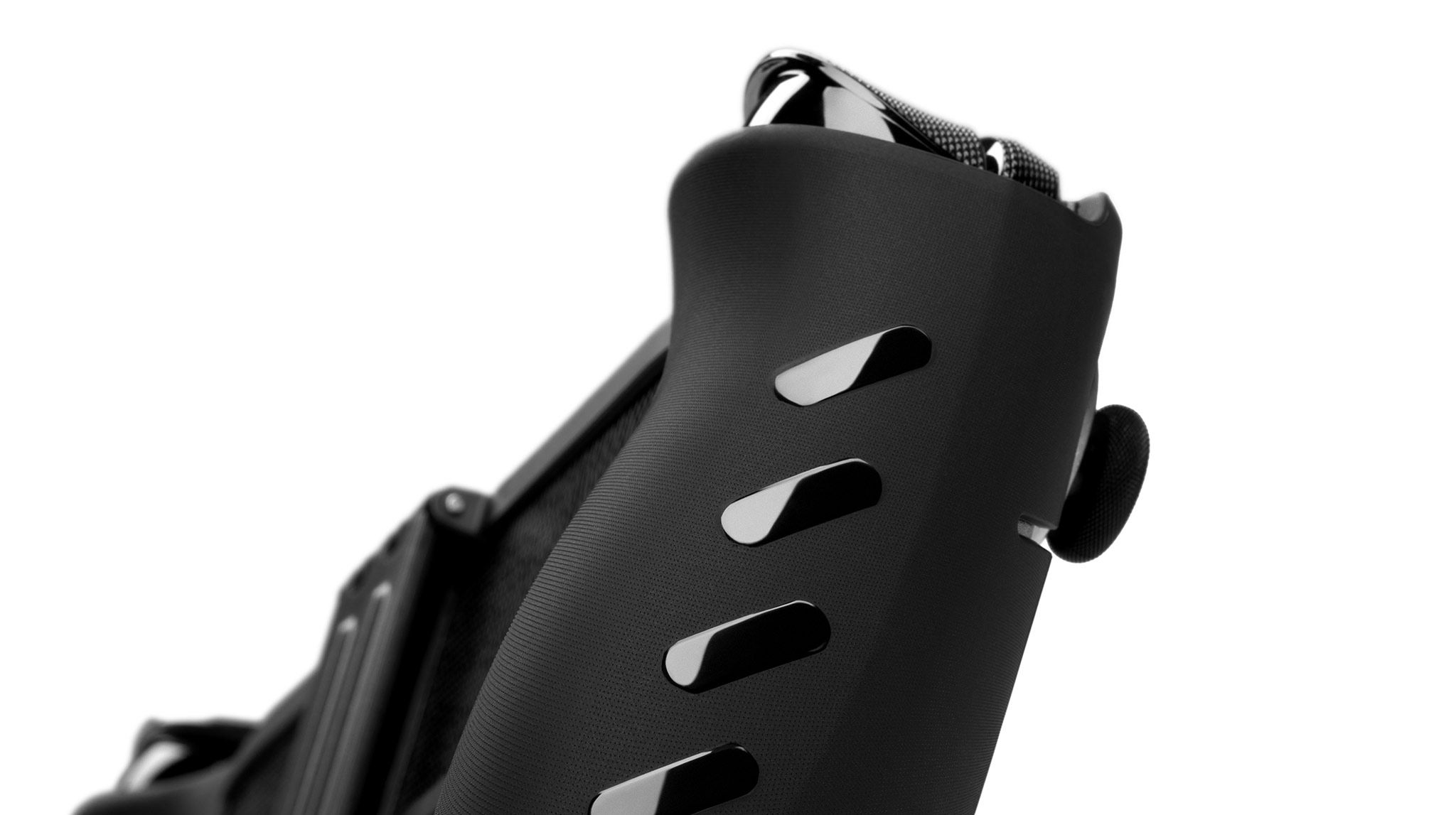 An ROG Xbox Ally X20 with our Killswitch applied to it, seen at a close-up angle from below by the side grips. Our liquid-black grip strips are visible on the side of the case.