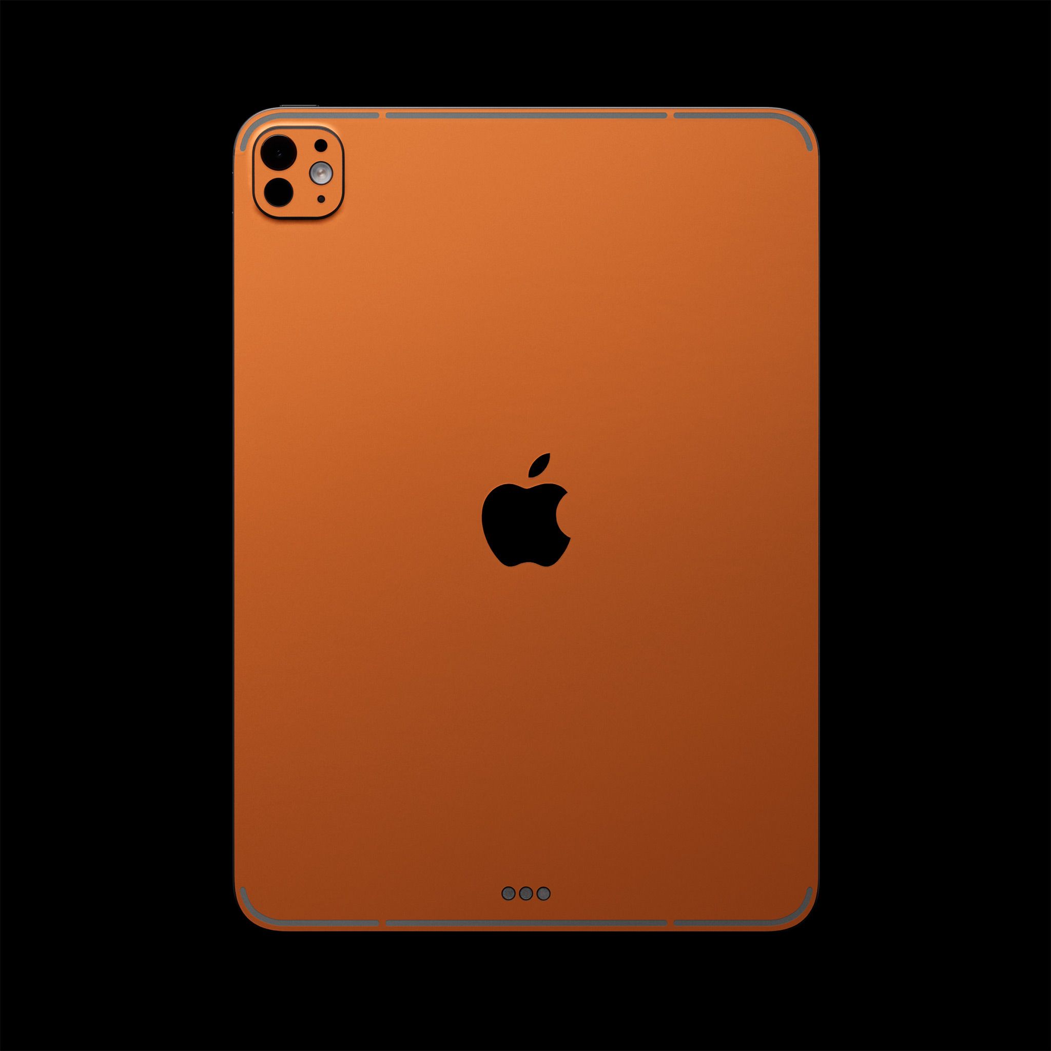 The back of an iPad Pro 13" (M4), with our Cosmic Orange Device Skin applied to it, covering the device except for the camera cutouts, the Apple logo, and the charging pins. There are also bespoke antenna cutouts. 