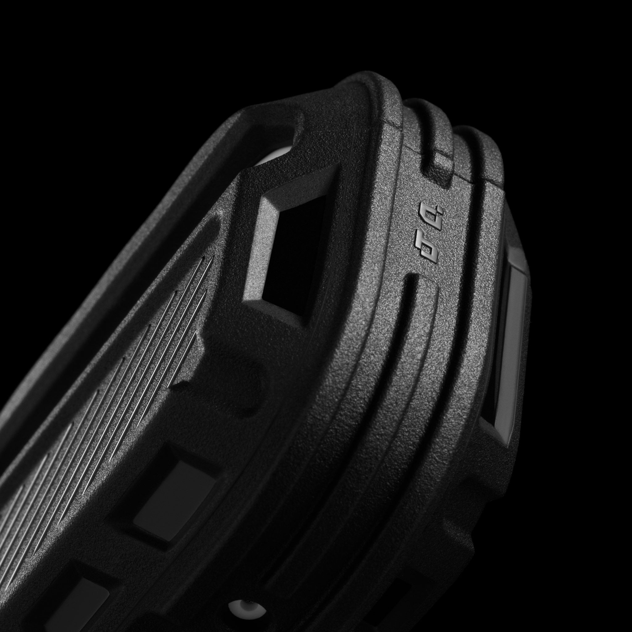 A close-up of the left side of our AirPods Pro 3 Tank Case, highlighting the varying topographical shifts in the case and the unique differing textures. 