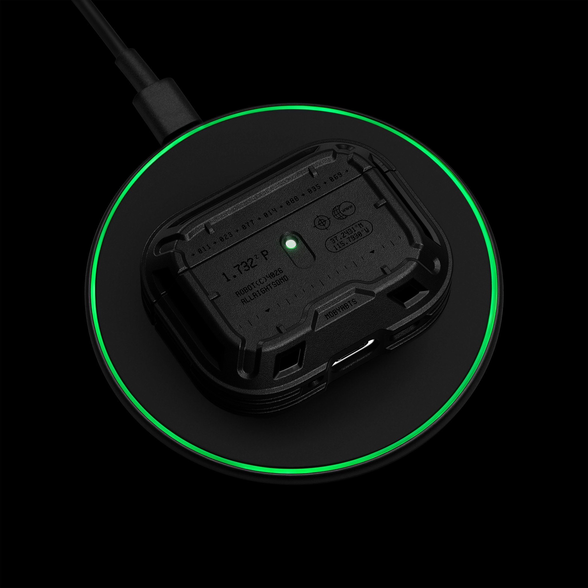 An AirPods Pro 3 with a Tank Case on it, placed on top of a disc-shaped wireless charger. The AirPods Pro 3 status light and the outline of the wireless charger are both lit green.