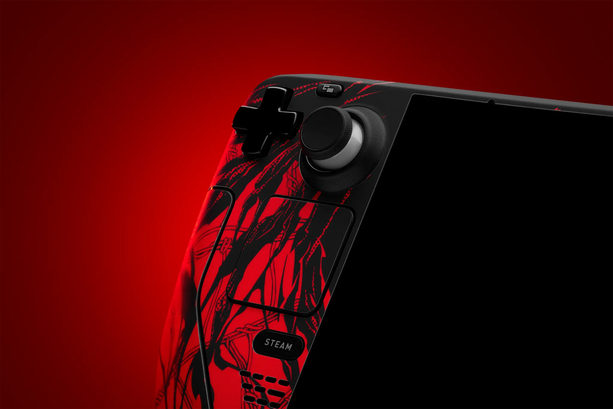 The left side of a Steam Deck, facing the viewer. The left face of the console has our Carnage Skin applied to it, covering the left face and the touchpad.